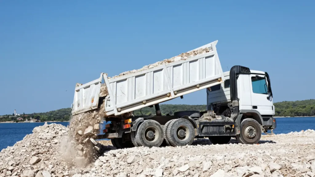 E4H image of a bottom tipper truck in the process of tiping rocks from the truck onto the ground