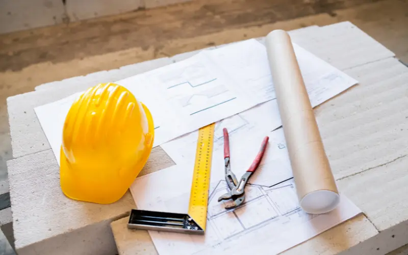 E4H image of a construction hat, papers, and tools